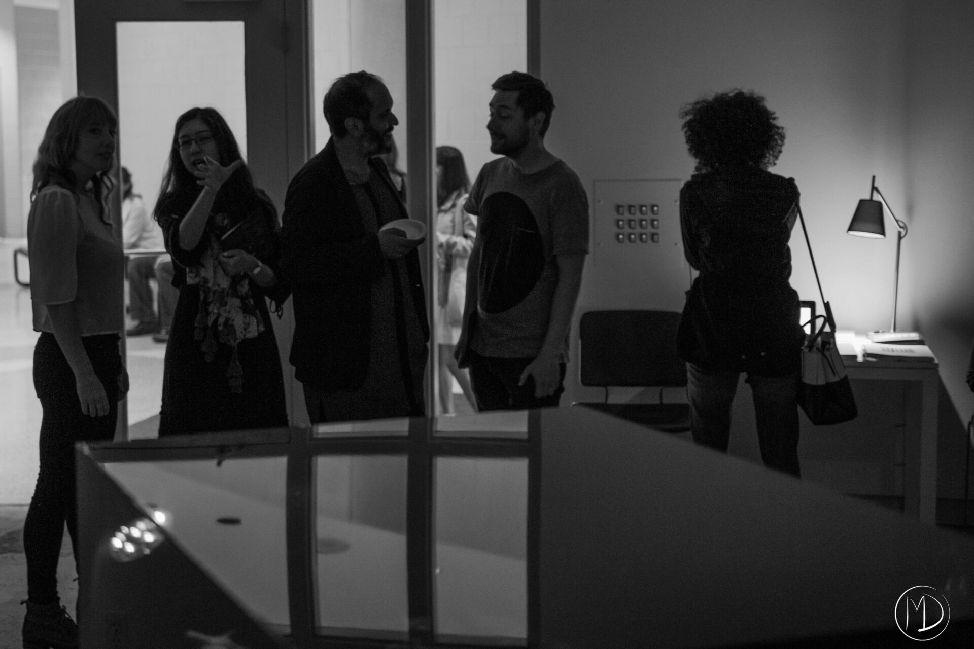 Mirjam and Sameer talking with visitors inside the gallery.